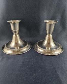 A pair of low silver candlesticks